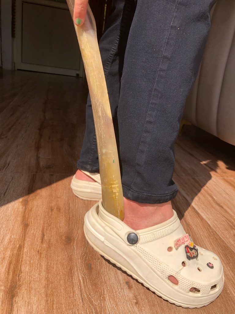 "Slip into your shoes with ease and keep them looking new with a durable shoehorn – the perfect tool for preserving your footwear’s shape and comfort."